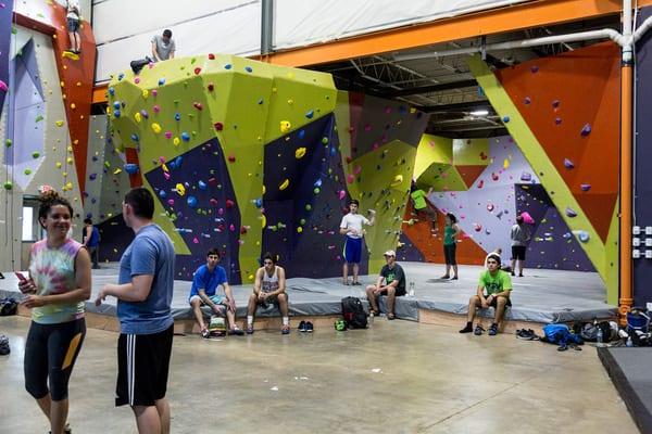 Our Bouldering course in the back, next to the top rope, lead rope, and American Ninja Warrior courses