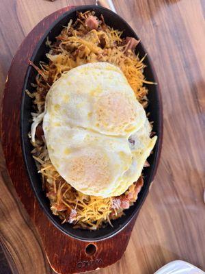 Meat lovers skillet with over easy eggs