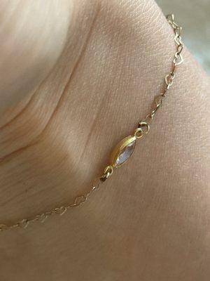 You can see the black spots where it was fused together. it's hard to tell in the photo, but the heart on the right side was welded wonky