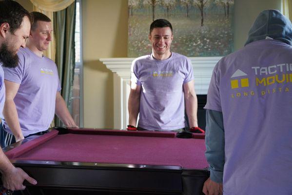 Strong and experienced movers lift heavy items with smile.