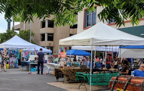 Both sides of the streets filled with vendors and some in the middle.