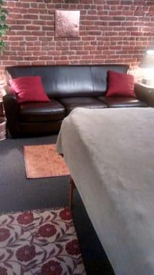 A cozy space floating above downtown Denver. Old-style brick, a comfy massage table & couch for your relaxation...