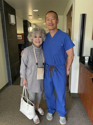 Dr Lee and my mom who was in a wheelchair before her surgery