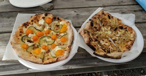 Delicious Pizza  Zucchini, sungold, roasted garlic and chevre on left Carmelized onion, roasted garlic, OLGA feta on the right