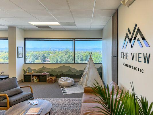 Waiting area and kids corner with the magnificent view of Denver downtown and the mountains.
