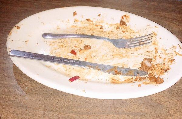 This is the plate after eating the chili cheese dog. She saved something for the dishwasher to do