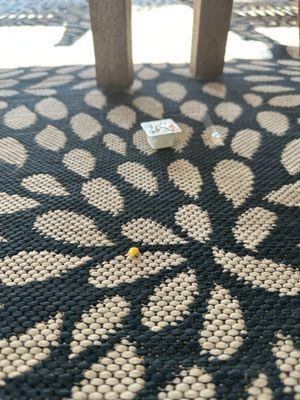 A pack of butter and crumbs left on the floor.