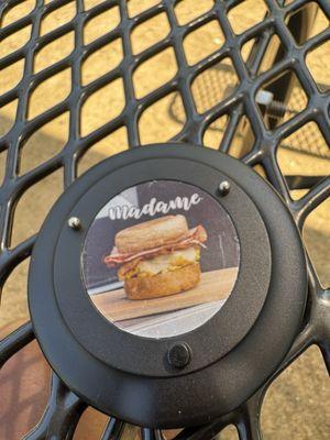 Buzzer for once your food is available featuring a picture of their Madame breakfast sandwich