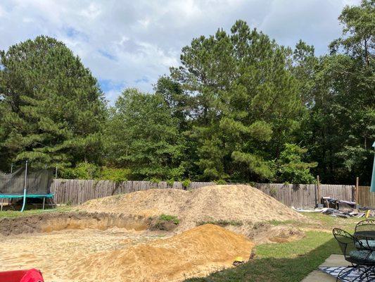 My entire backyard , with the trampoline stuck behind the mess because they didn't move it before digging as james said he would