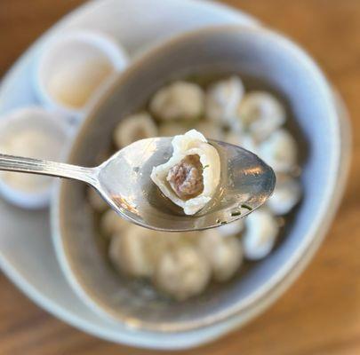 Pelmeni: Halal Beef Dumplings w/ bone broth, chive oil, dill, apple cider vinegar, tartar cream | $16