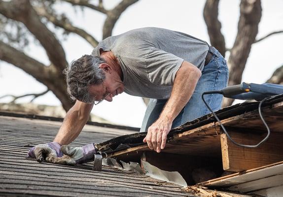 Tom checking out a leaking roof at one of our customer's locations.