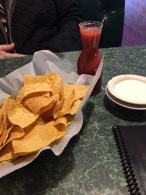 Chips and salsa with ranch type dipping sauce