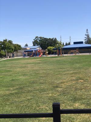 Grass field, children's play areas.