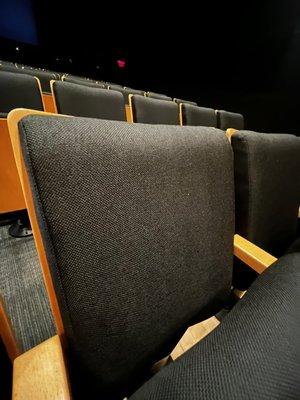 Reupholstered seating in a durable seating fabric for an auditorium.