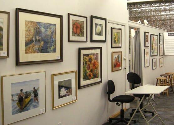 At one of our ArtWalks, art pieces are displayed along the studio wall.