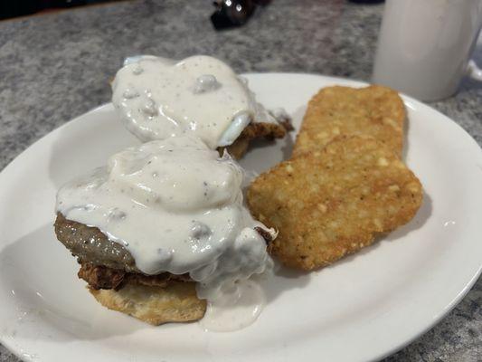 CowBoy Benedict 2 Poached eggs buttermilk biscuit with crispy chicken and topped with our house made gravy served with home fries
