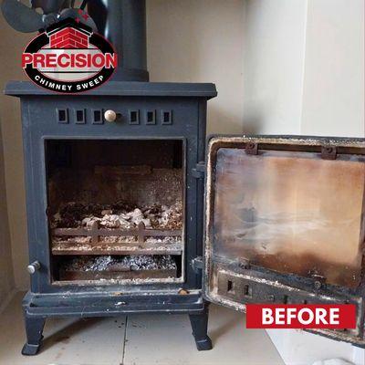 BEFORE: Dirty wood stove interior with ash and residue build-up before cleaning