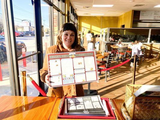 Linda proudly holding her menu