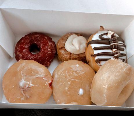 Red velvet, pumpkin spice with cream cheese, black & white cream cheese, raspberry and lemon filled and glazed.