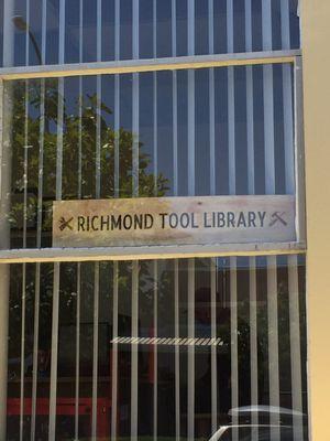 Sign overlooking the sidewalk outside