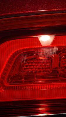 Smears/scratches on taillight from sloppy handling of the polisher.