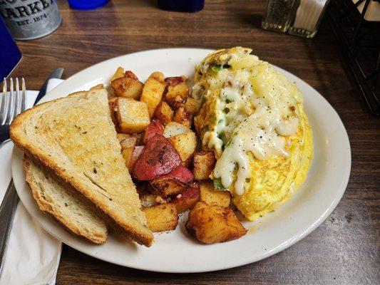 A huge omelet, home fries, and toast