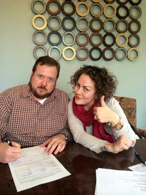 Happy customers, Taryn and John Goodwin, closing the loan on their new house at Capitol Abstract Nichols Hills.
