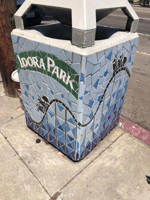 Mosaic art on garbage receptacles.