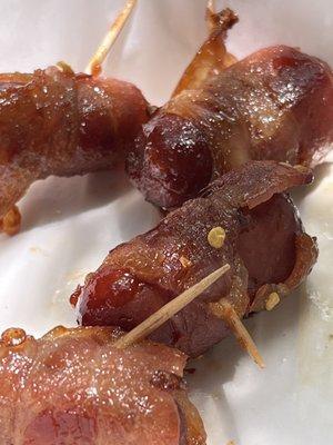 Man candy. Sausages wrapped in bacon with chili sauce.