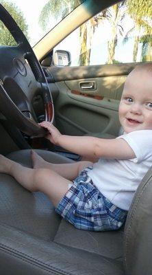 Jacob at about a year old pretending to drive my car.