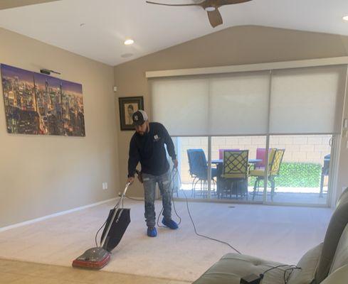 That's George putting the finishing touches on our new carpet.