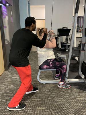 Trainer & client on the cable machine