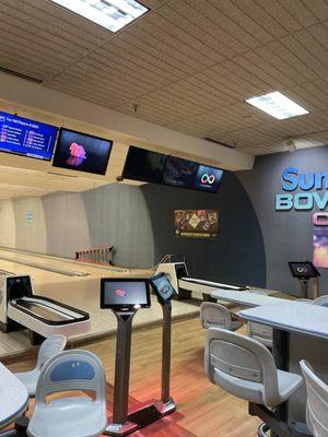 Bowling floor, tables, tvs.