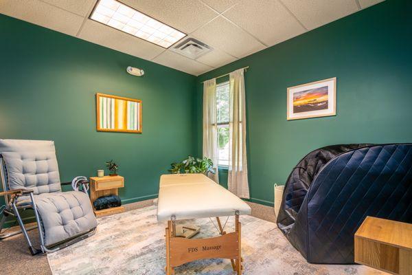 Climb Chiropractic therapy room with full-spectrum infrared/red light therapy sauna and BrainTap brain fitness experience.