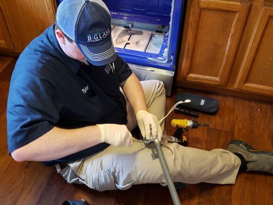Our newest technician Tyler installing a new igniter on a burner assembly of a LG gas range.