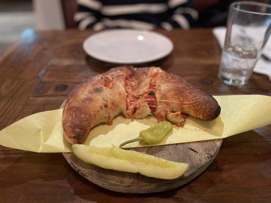 Specialty pizza - Stromboli : pizza crust stuffed with Italian sauce, cheese, Italian sausage, and zucchini.