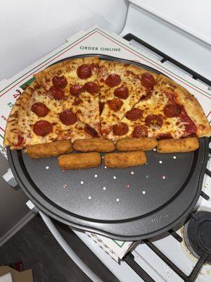 half of my pepperoni pizza with my order of Mozzarella Sticks (6 pcs). i personally like to warm mine up in the oven for about 5 minutes