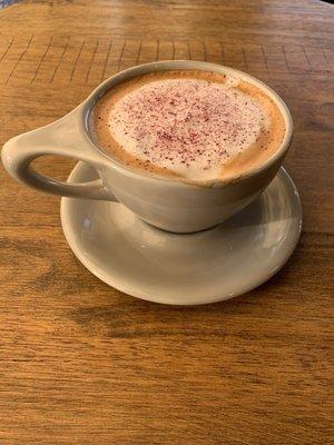 Wet cappuccino with a dash of rose- cardamom powder