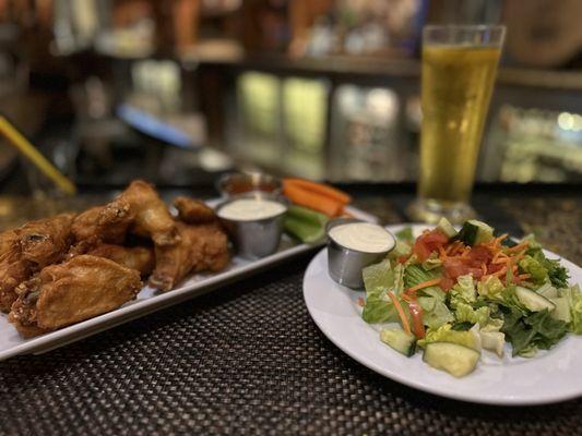 Wings and salad with blue cheese all around