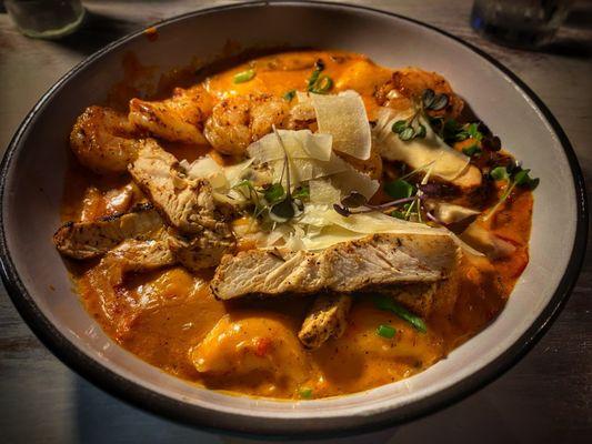 Cajun Gnocchi - Blackened chicken, shrimp, & andouille sausage served with a Cajun cream sauce, roasted red peppers & green onions
