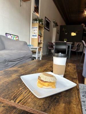 Breakfast sandwich with sausage and a Carmel latte with an extra shot of espresso.