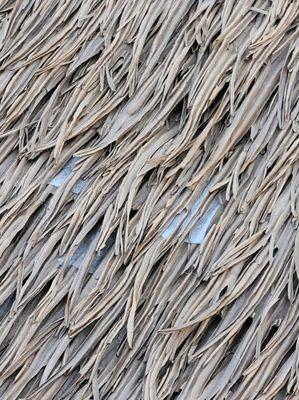 White plastic that company refused to cover up. It's hard plastic that's stuck in there. Cannot hide without more thatch.