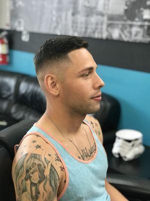 Skin fade on sides and back with comb-over on top.