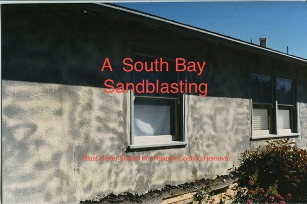 Exterior stucco home paint stripped to bare original stucco.