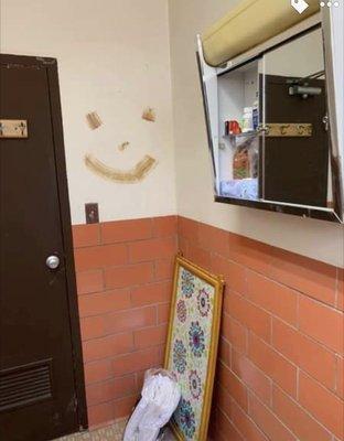 Brown smile on the wall in bathroom