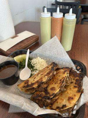 Quesabirria tacos with consume- some of the meat was a little fatty. Overall very tasty! Served with 3 hot sauce all good!