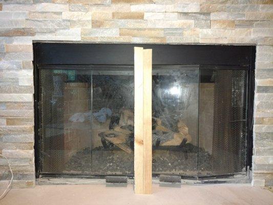 Stone work on fireplace is uneven. The owner sent the same guy out to fix it. It still remains uneven & the old tile behind it is visible.