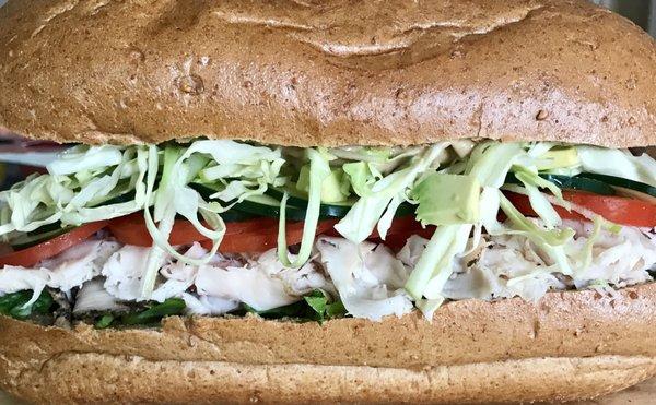 Iron Man - Lettuce, turkey, sliced tomatoes, cucumbers, cali slaw and pomegranate mustard.