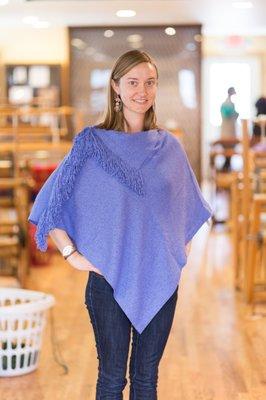 A poncho woven in solid boucle yarn.