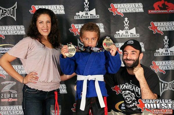 Coach Ash and Coach Cris with one of their students at grappler's quest.
